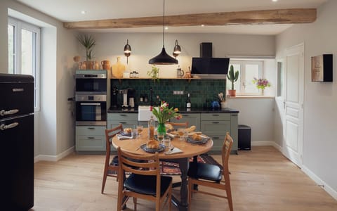 Fully-equipped kitchen with oven, dishwasher, fridge, pots & pans, flatware, dishes, glassware, etc.