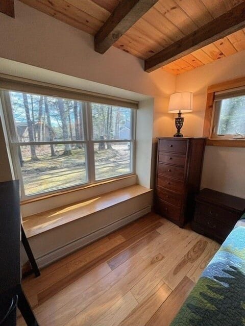 Primary bedroom has an awesome bench, to sit and put on your shoes or lay out your outfits