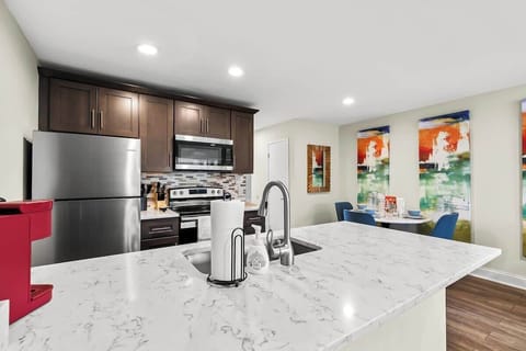 Fully stocked kitchen including pots/pans/mixing bowls/utensils and spice rack.
