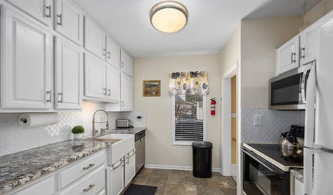Efficient galley kitchen with beautiful granite countertops.