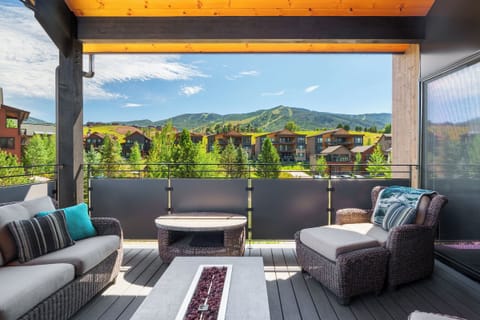 Elevate townhome with outdoor living space with hot tub, cozy seating around the firepit and a flat screen TV!