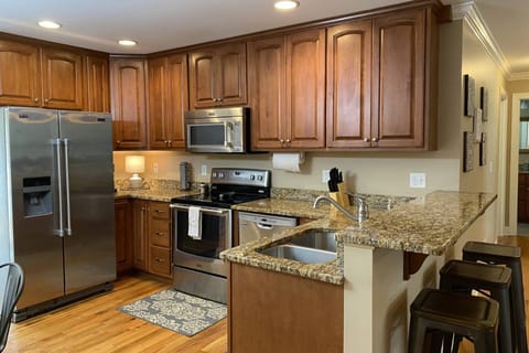 Fully stocked kitchen in "Tennessee Delight 4" has ample dishes, glasses, silverware, bowls, pots and pans for quick food on the run or full meals.