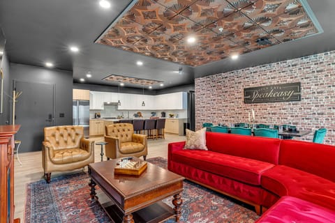 Open-floor living space featuring a smart flat-screen TV and designer furnishings. This inviting area effortlessly connects the dining space with the well-appointed kitchen.