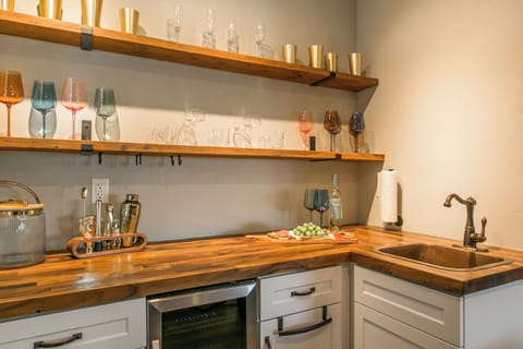 Kitchenette at the living room with cocktail shakers and aesthetic sink