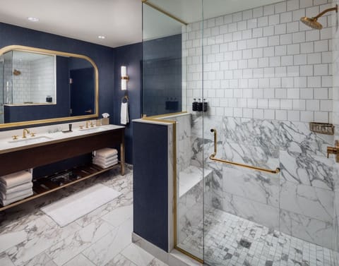 Refresh in a spa-like marble bath with rainfall shower.