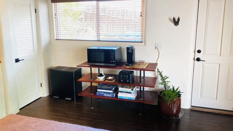 Microwave/coffee station with door exiting to grilling patio.