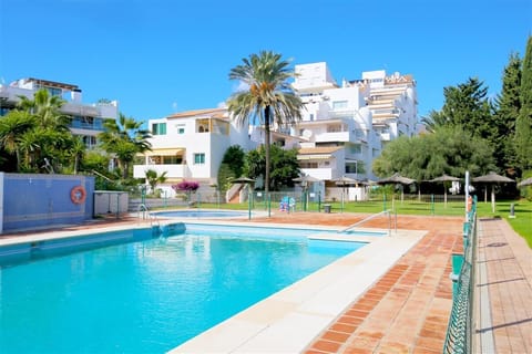Stunning communal pool area surrounded by gardens