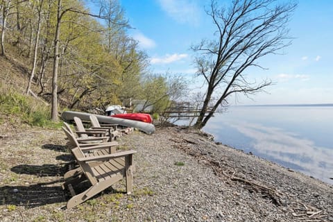 Lakefront / Boathouse / Dock (requires three flights of stairs to access)  -  Bask in the tranquility of our private lakeside beach, featuring comfortable loungers and direct water access, perfect for a serene day by the lake.