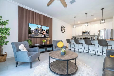 Step into this spacious, comfortable living area. The expansive room is adorned with tasteful decor, offering a blend of modern aesthetics and homey warmth. 