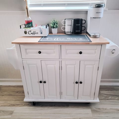 Toaster, crockpot, drip coffee maker, and blender located in cabinet.