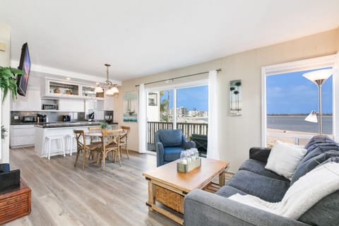 Modern kitchen meets cozy lounge with stunning beach views.
