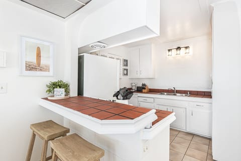 Though small, the efficient kitchen in this beachfront property is where you can prepare your delights while still enjoying panoramic ocean views.
                