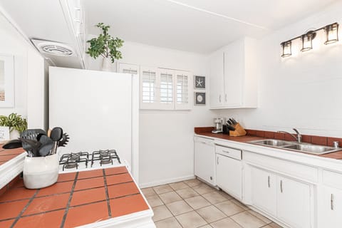 Though small, the efficient kitchen in this beachfront property is where you can prepare your delights while still enjoying panoramic ocean views.
                