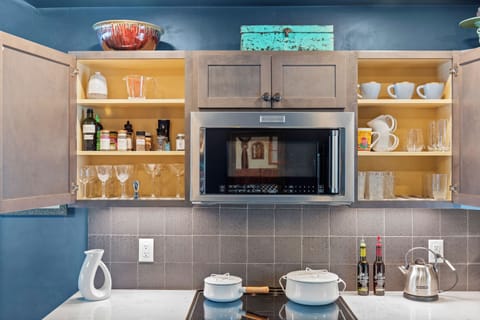 Dining setup stocked w/ serveware for shared meals.

