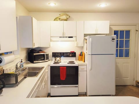 Fully stocked kitchen has refrigerator, electric stove, microwave, dishwasher, toaster, drip coffee maker, blender and more
