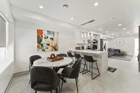 A sleek dining room, with an open kitchen concept for the best dinners.