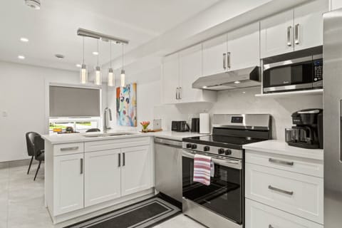 Pendant lights above the island create a sculptural focal point.