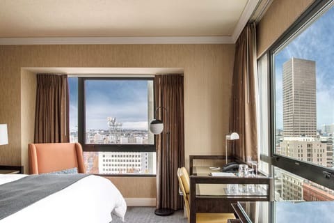 An elegant room featuring a plush king bed, complete with a cozy seating area and warm, inviting decor.