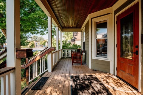 Watch the world from this peaceful porch with cozy seating 🌳🪑