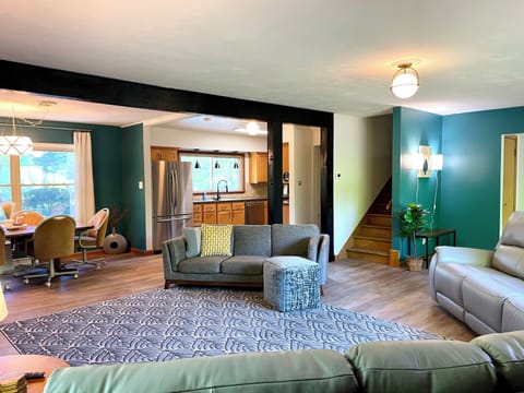 Open Concept for Gatherings! The open-concept living room at Riverside Paradise is perfect for connecting. Kids can play, families can dine, and everyone can enjoy movies on the 65" Fire TV. Custom wall art adds a unique touch to this spacious haven