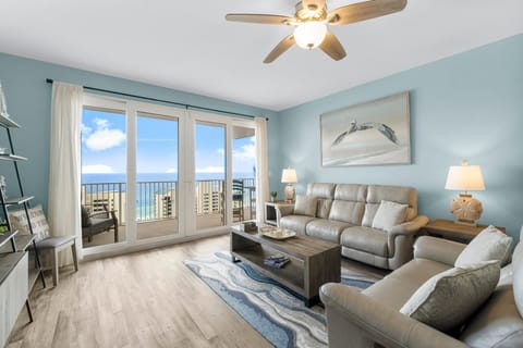 Relax in this coastal living room with ocean views through large glass doors.