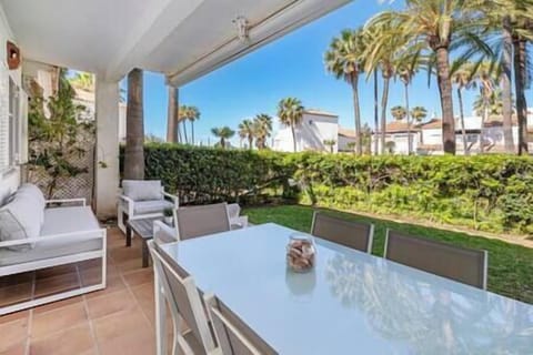 Garden area with comfortable furniture to relax or enjoy a nice meal outdoors enjoying green lawn. (1)