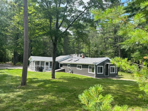 Main cabin w/screen porch facing the water.  4 buildings total.