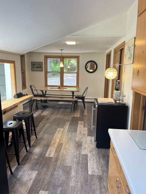 Kitchen extends with coffee/smoothie counter and large hardwood dining table