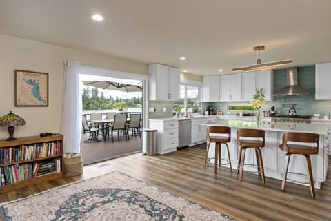 A dream kitchen with lake views and open doors to the patio. Perfect for summer!