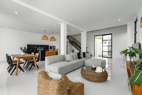 Bright and airy open-plan living space, modern kitchen, and comfy lounge area.