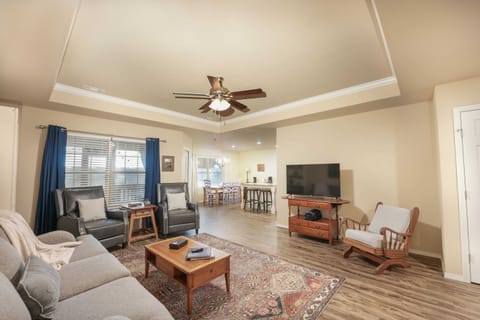 Relax in our cozy living room, featuring plush seating, a smart TV, and rustic touches.
