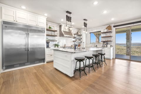 Our top-of-the-line kitchen is fully stocked and features a huge island with extra seating.