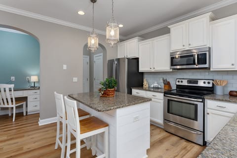 [Kitchen] Island featuring breakfast bar seating for two.