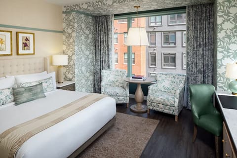 Wake up refreshed in a chic room with soft seating.