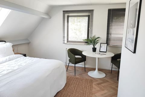 Room 1 has comfortable chairs and a table.