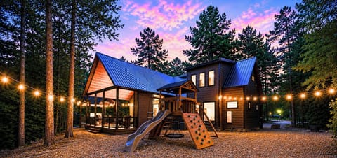 Family-friendly fun awaits! This beautiful cabin comes with an outdoor playset featuring a slide, climbing wall, and swing—perfect for keeping the little ones entertained while you relax on th