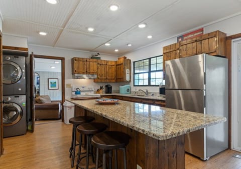 Kitchen with island, fridge, dishwasher, stove, microwave