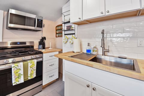 A newly remodeled and nice sized kitchen with butcher block countertops and center island