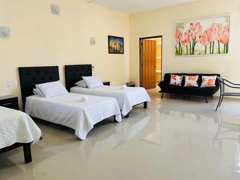 Bedroom with double bed, two twin beds and sofa cama