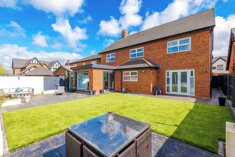 Wide angle view of the garden and rear of the property