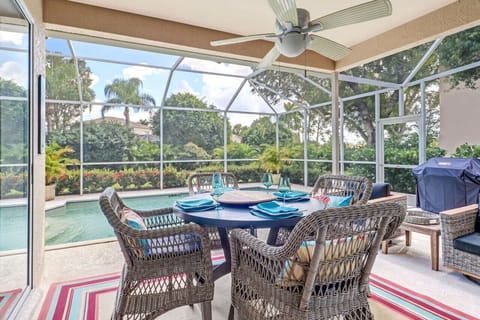 Screened patio area with heated pool, sun loungers, dining and lounging areas, a gas grill, outside TV and giant Connect 4 game. Perfect for Florida living in the sunshine!