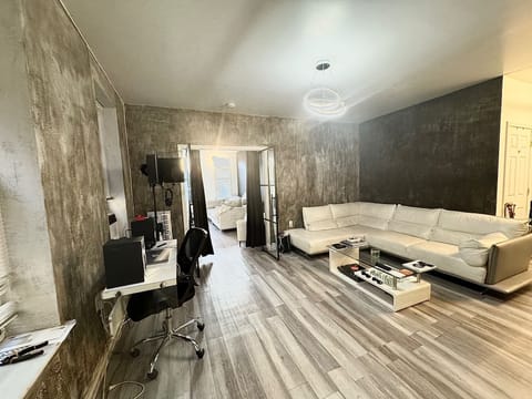 Living room area with beautiful glass doors that lead into one of the rooms.