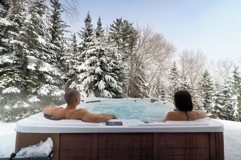 Soak in the hot tub surrounded by snow.