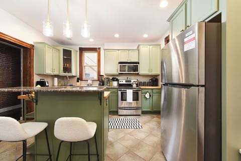 Fully equipped kitchen with kitchen island and bar seating for 2