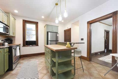 Fully equipped kitchen with sunlight coming in from the window