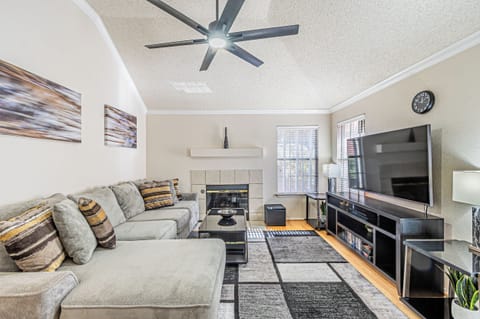 Spacious upstairs living area with 65-inch Roku Smart TV and plenty of seating.