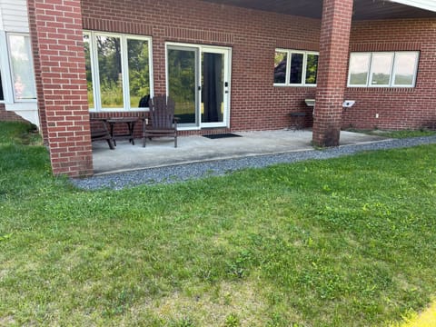 Guest suite entrance and patio area with outdoor grill.
