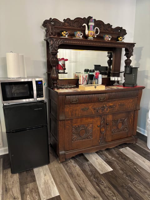 Microwave, mini fridge, stocked coffee and tea bar with Keurig coffee maker.