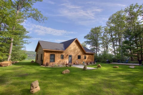 Front of House with Spacious Front Lawn Area and Patio with Seating