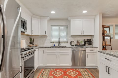 Kitchen is equipped with ample cupboards and cabinets